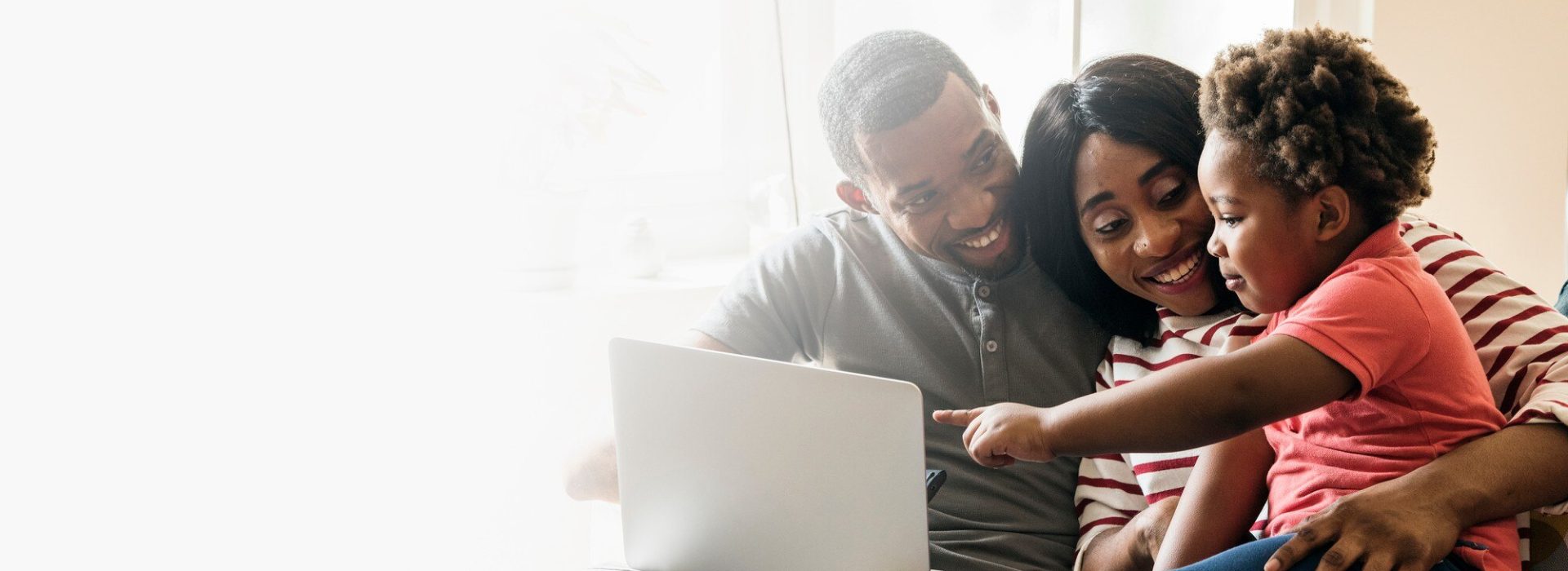 happy-black-family-toddler-pointing-laptop-screen-design-space_53876-97128